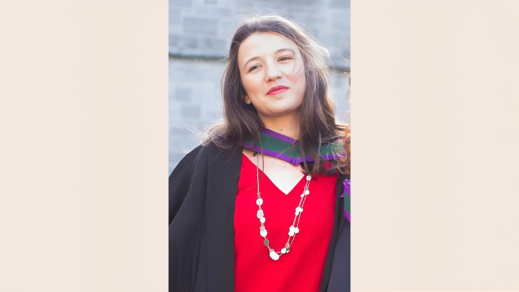 Young woman wearing graduation robes